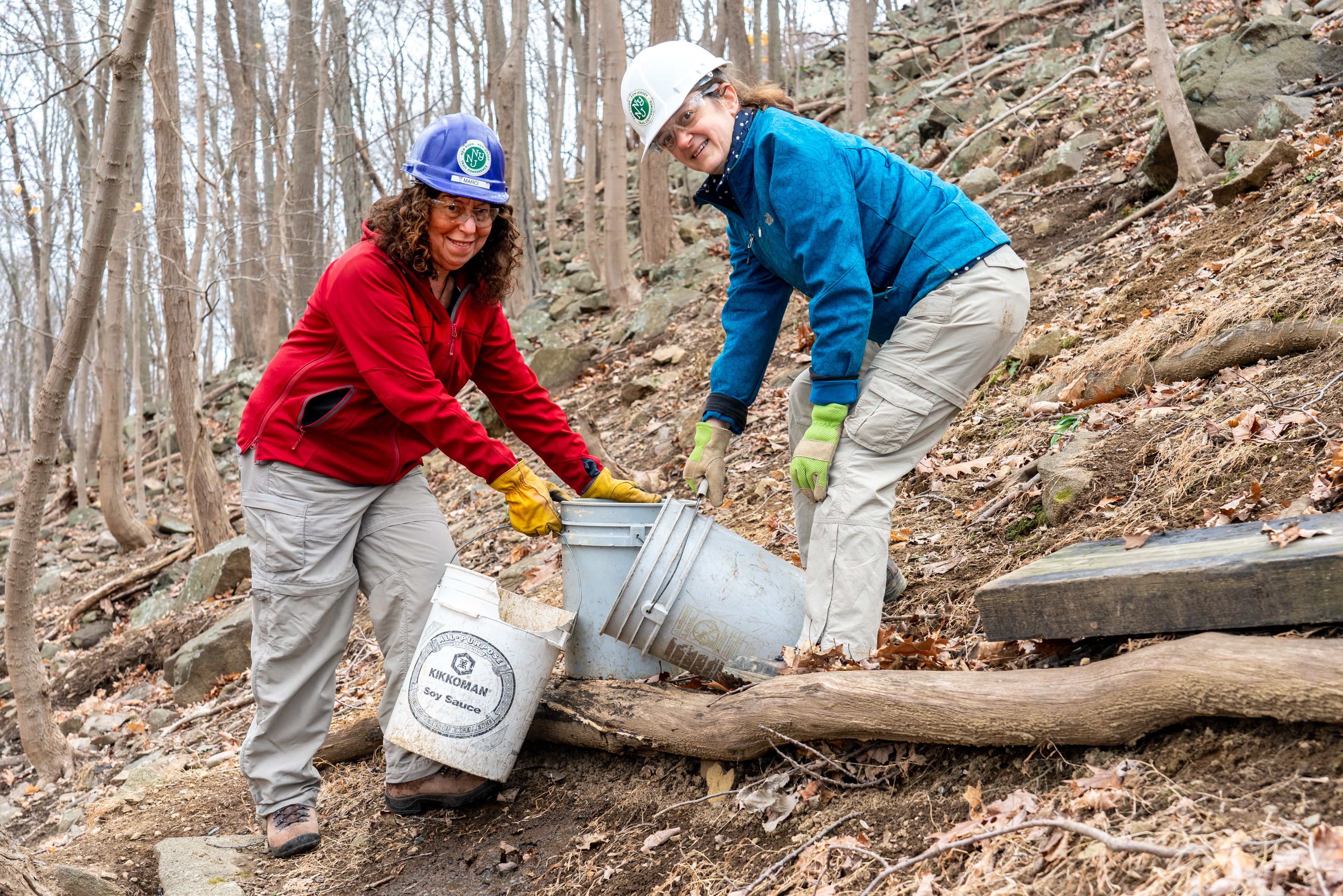 Two Long Distance Trails Crew members holding buckets