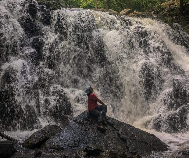 Conservation Corps Crew Member Nicole Vargas at the waterfall at Ramapo Valley County Reservation.