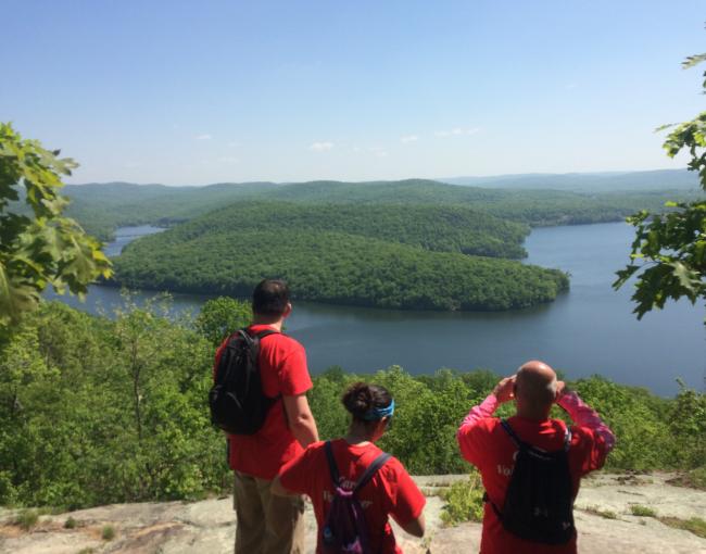 Hikers enjoy a scenic overlook of a lake in Norvin Green State Forest. Photo by Peter Dolan.